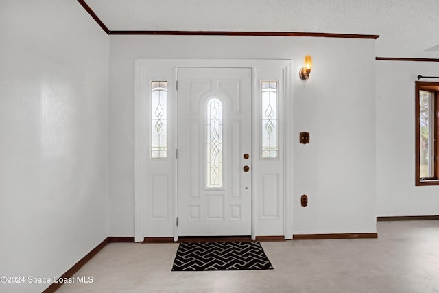 entrance foyer featuring light colored carpet