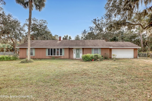 single story home featuring a garage and a front lawn