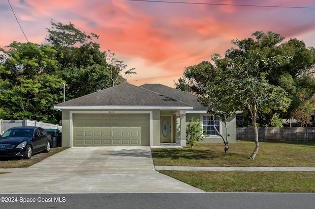 view of front of home featuring a yard and a garage