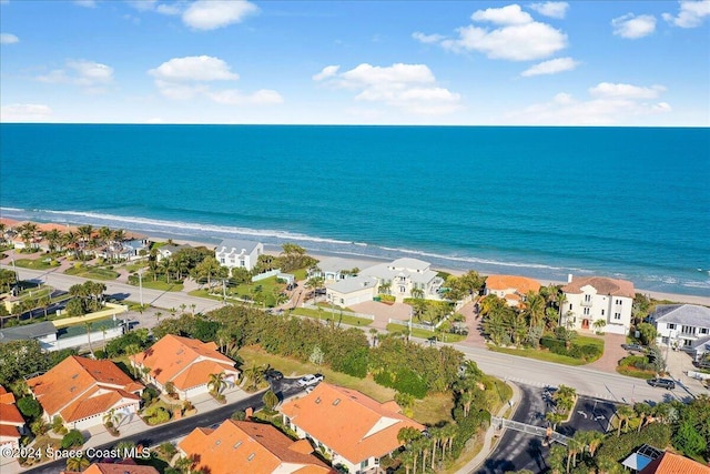 aerial view with a water view and a beach view