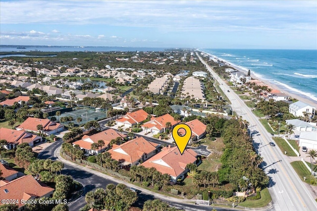 drone / aerial view featuring a water view and a beach view