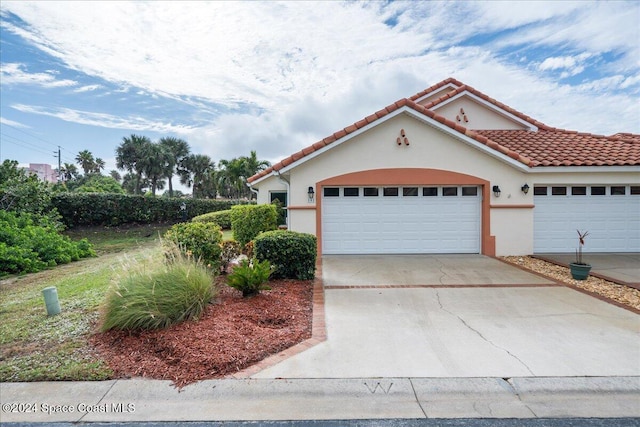 mediterranean / spanish home with a garage