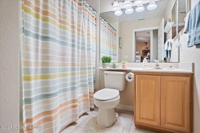 bathroom featuring tile patterned floors, vanity, and toilet