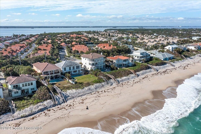 bird's eye view featuring a beach view and a water view