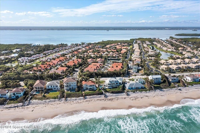 bird's eye view with a water view and a view of the beach