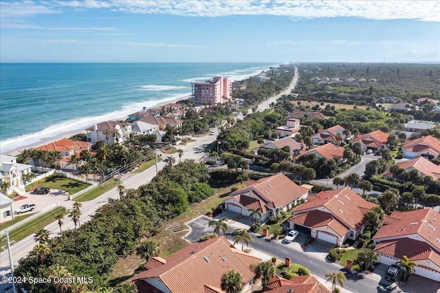 drone / aerial view with a beach view and a water view