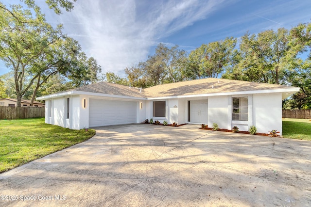 ranch-style home featuring a front yard and a garage