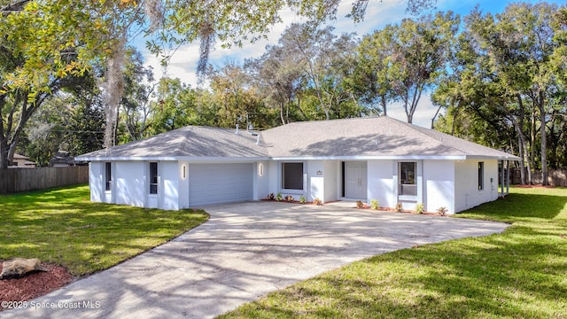 ranch-style house featuring a garage and a front lawn