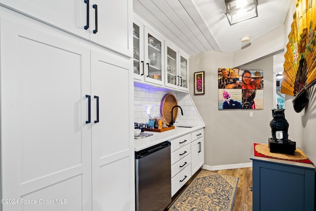 interior space featuring white cabinets, sink, decorative backsplash, stainless steel fridge, and dark hardwood / wood-style flooring