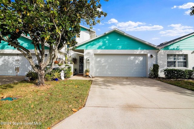 view of front facade with a garage and a front yard