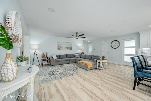 living room with light wood-type flooring and ceiling fan