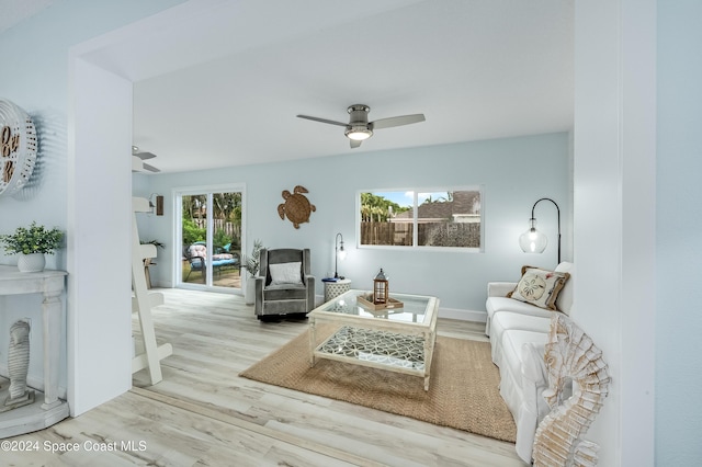 living room with light hardwood / wood-style floors and ceiling fan