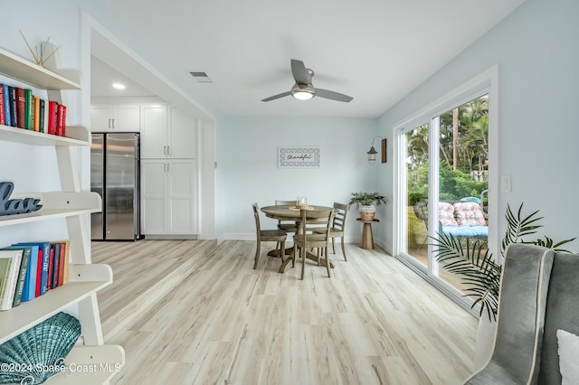 dining space featuring ceiling fan and light wood-type flooring