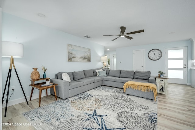 living room featuring light hardwood / wood-style floors and ceiling fan