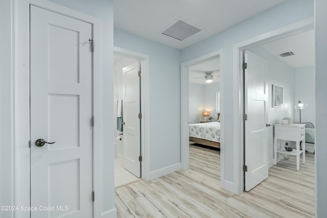 corridor with light hardwood / wood-style flooring