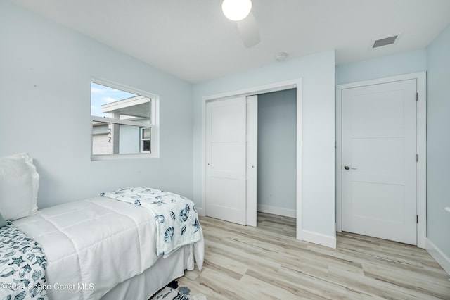 bedroom featuring light wood-type flooring, a closet, and ceiling fan