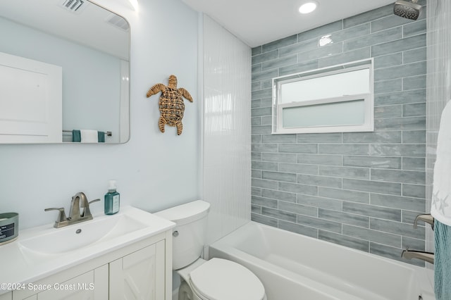 full bathroom with tiled shower / bath combo, toilet, and vanity