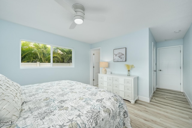 bedroom with ceiling fan and light hardwood / wood-style floors