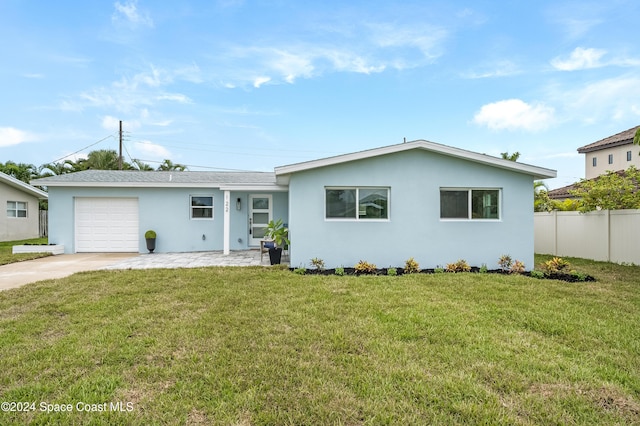 ranch-style home with a garage and a front lawn