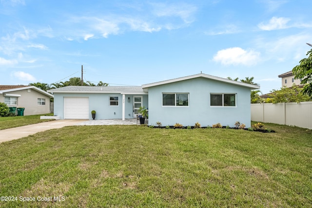 ranch-style home featuring a front lawn and a garage