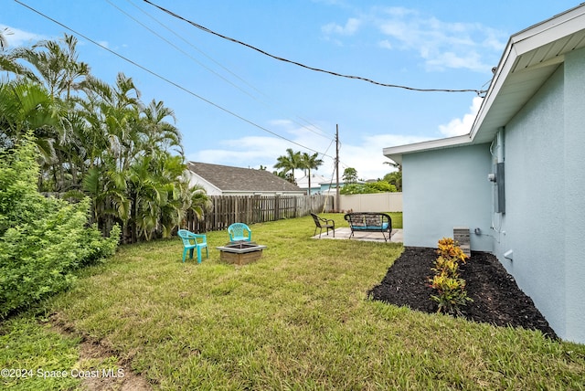 view of yard featuring a patio and an outdoor fire pit