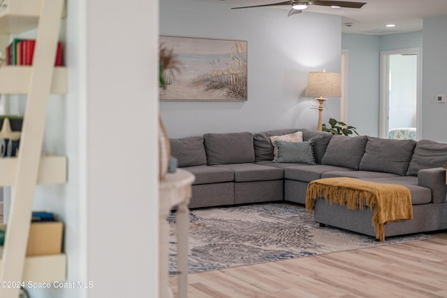 living room with ceiling fan and hardwood / wood-style floors