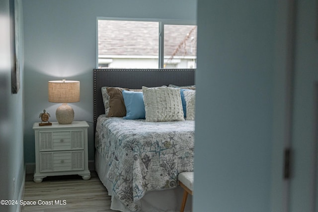 bedroom with wood-type flooring