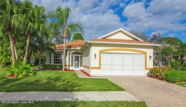 view of front of house with a front yard and a garage