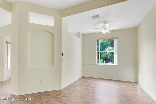 spare room featuring light hardwood / wood-style floors and ceiling fan