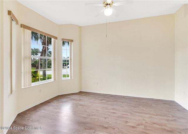 empty room with hardwood / wood-style floors and ceiling fan