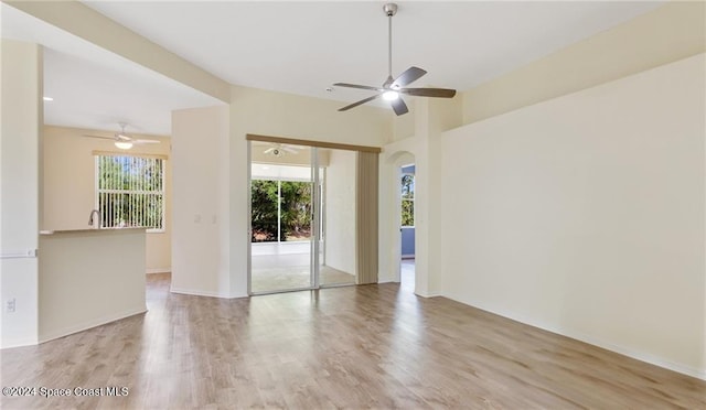 unfurnished room featuring ceiling fan, light wood-type flooring, and a wealth of natural light