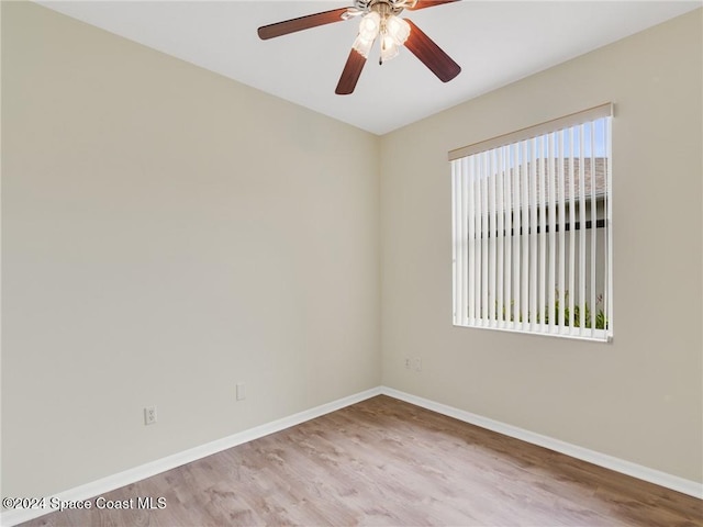 spare room featuring ceiling fan, light hardwood / wood-style floors, and a wealth of natural light