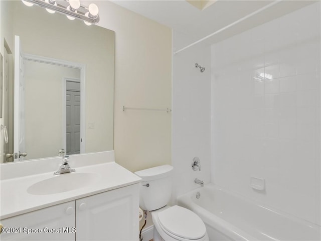 full bathroom with vanity, tiled shower / bath combo, and toilet