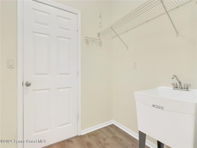 washroom featuring hardwood / wood-style flooring and sink