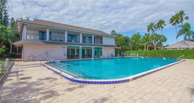 view of swimming pool with a patio