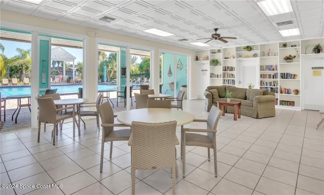 sunroom featuring ceiling fan