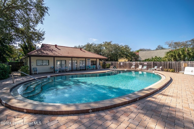 view of swimming pool featuring a patio area