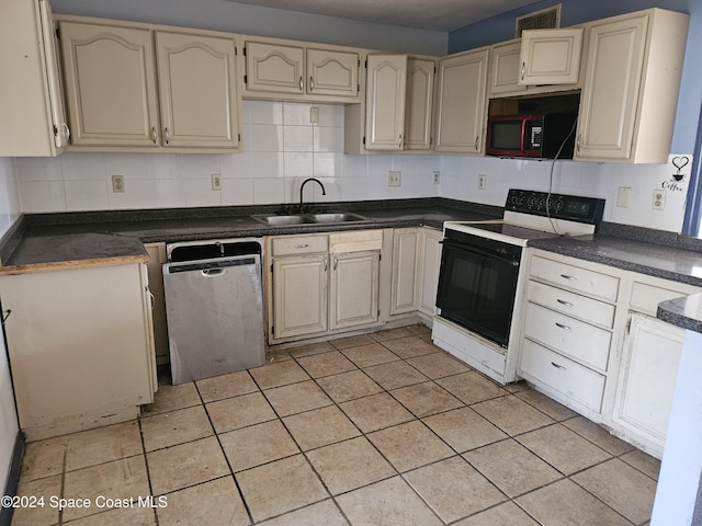 kitchen with tasteful backsplash, sink, black appliances, and cream cabinetry