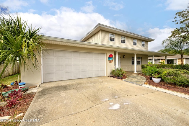 view of front of home featuring covered porch and a garage