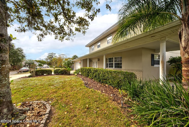 view of side of property with a lawn