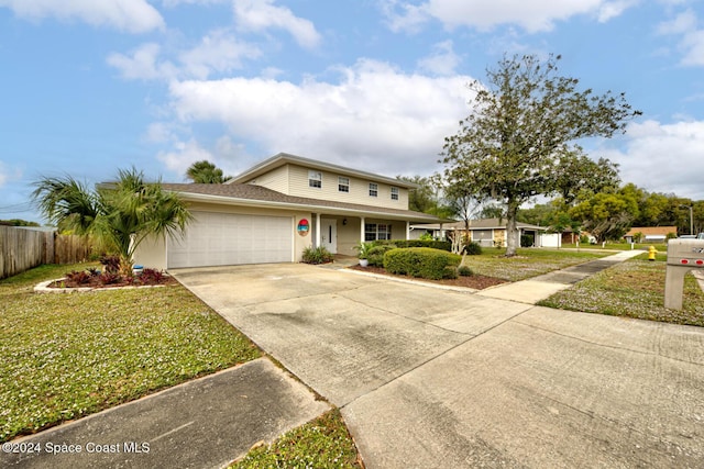 view of front of home featuring a garage and a front lawn