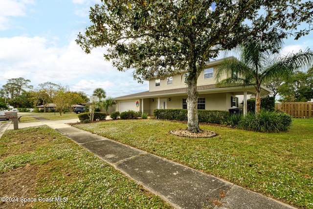 view of front of house with a garage and a front lawn