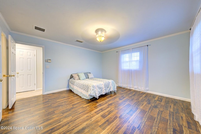 bedroom featuring ornamental molding and dark wood-type flooring