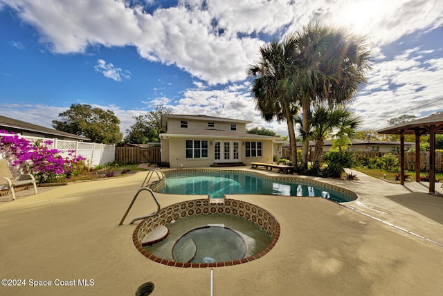 view of pool with an in ground hot tub and a patio