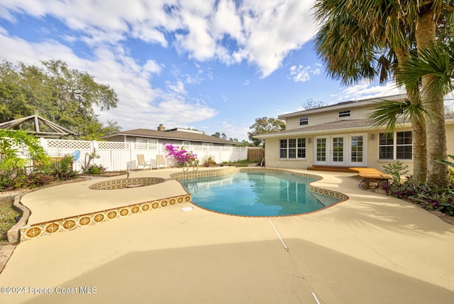 view of pool featuring french doors and a patio area