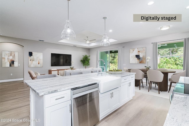 kitchen featuring dishwasher, sink, decorative light fixtures, white cabinets, and light wood-type flooring