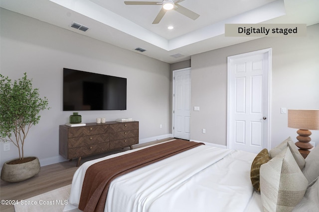 bedroom with light hardwood / wood-style floors and ceiling fan