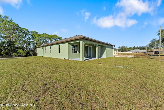 view of property exterior featuring a patio area and a yard