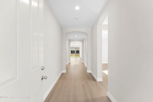 hallway with light hardwood / wood-style floors