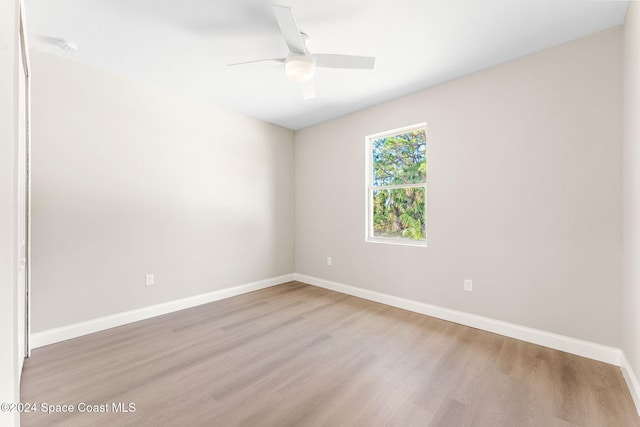 empty room with ceiling fan and wood-type flooring